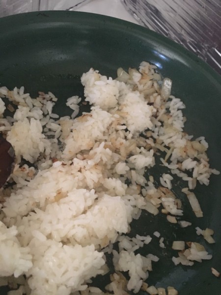 rice and onion in pan