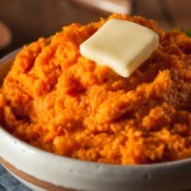 bowl of mashed sweet potatoes with a pat of butter