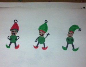 three fingerprint elves on white paper