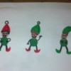three fingerprint elves on white paper