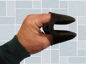 A silicone kitchen mitt on a hand.