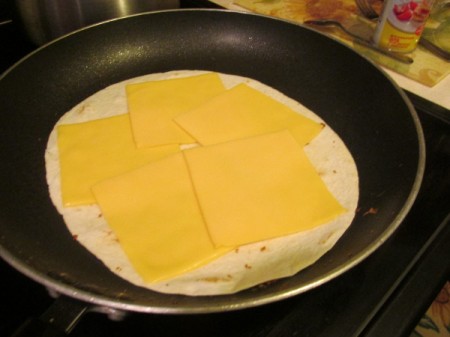 tortilla with cheese in pan