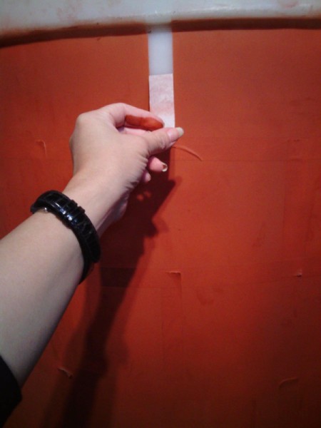 removing vertical  tape to reveal the brick pattern