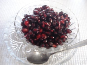 Pomegranate Deseeding- A bowl of pomegranate seeds, ready for eating.