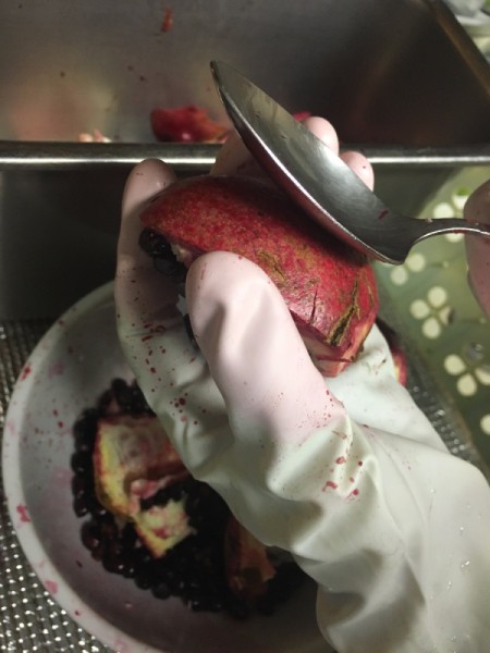 Pomegranate Deseeding - Using a spoon to remove seeds from pomegranate.
