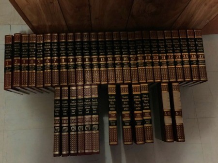 set of encyclopedias standing on the floor