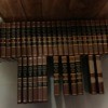set of encyclopedias standing on the floor