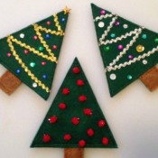 Three Christmas tree treat holders made from felt.