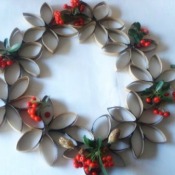 A wreath made from cardboard sections of a paper towel tube.