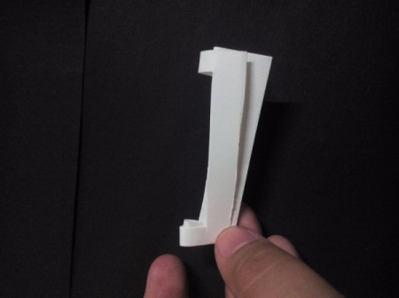 folded white paper with shallow rectangle cut away for belt buckle