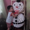 little boy hugging the snowman