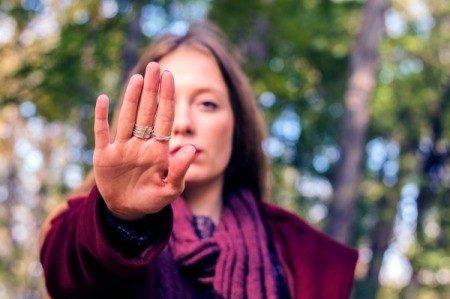 A woman holding up her hand to stop someone.