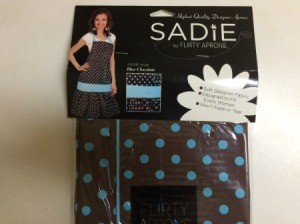 chocolate brown apron with blue dots in package