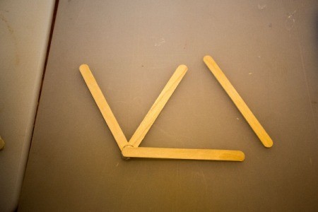 Popsicle sticks glued as a double "v".