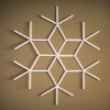 A finished popsicle stick snowflake, painted white.