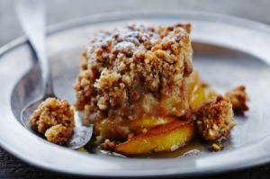 A serving of apple crisp on a plate.