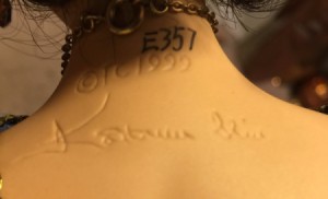 Photo of a mark on the back of a doll's neck.