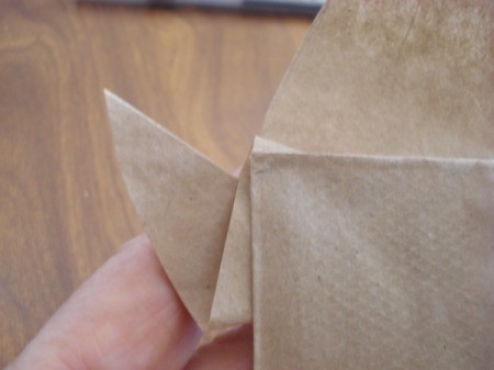 Closeup view of the folder reindeer bag ears sticking out from the side of the bag.