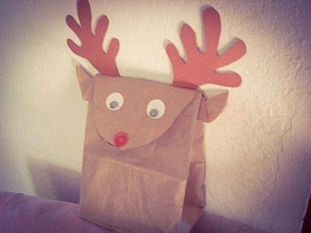 Reindeer bag sitting on the back of a chair or couch.