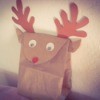 Reindeer bag sitting on the back of a chair or couch.