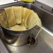 A pot of lasagne noodles, cooked and drained.