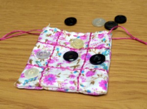 Fabric and Button Tic-Tac-Toe Game - finished game pouch with two markers on board