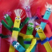 A bunch of puppets made from popsicle sticks.