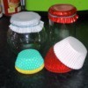 Paper cups for muffins or cupcakes on top of glass jars.