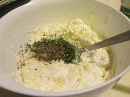 Alfredo Spinach Lasagna - mixing ricotta, herbs, and eggs in bowl.