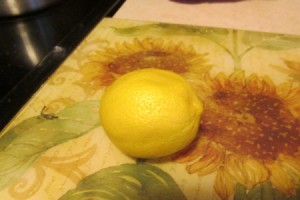 Using Lemon as an Odor Remover - whole lemon on flowered cutting mat