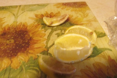 Using Lemon as an Odor Remover - wedges of lemon on a flowered cutting mat