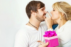 A girl giving her boyfriend an anniversary gift.