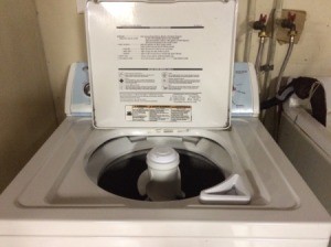 A washing machine with the lid open.