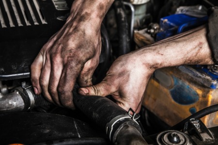 Hands covered in auto grease.