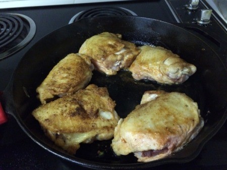 chicken frying in pan