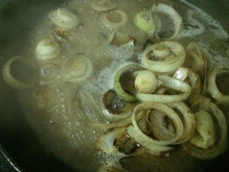 broth added to fried onions in skillet