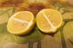A yellow lemon cut in half, ready for use.