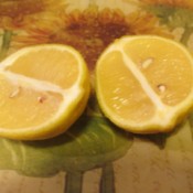 A yellow lemon cut in half, ready for use.