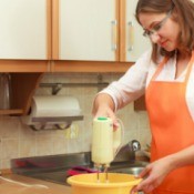 A woman using a mixer.