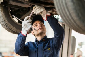 A mechanic working on a car.