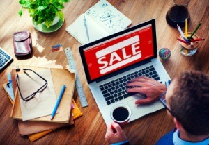 A man using his laptop to shop.