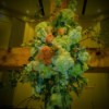 A cross adorned with flowers for a wedding.