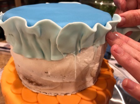 'Sharky' Goldfish Birthday Cake - begin adhering the light blue strips and ruffle as you go
