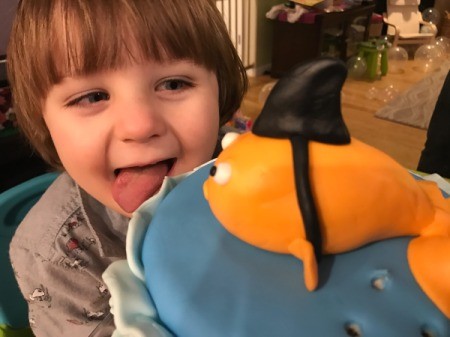 'Sharky' Goldfish Birthday Cake - little boy licking cake