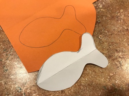 Goldfish Party Treat Bags - template and view of fish shape traced onto orange paper