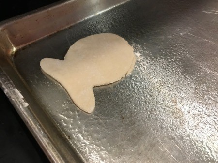 Goldfish Shaped Mini Pizzas - one fish shaped pizza on baking sheet