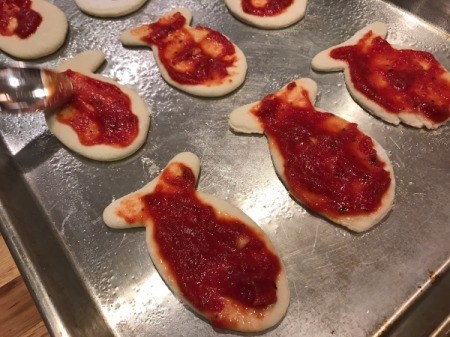 Goldfish Shaped Mini Pizzas - mini pizzas covered with pizza sauce