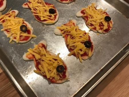 Goldfish Shaped Mini Pizzas - single black olive slice placed for eye