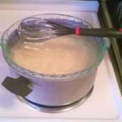 A pie plate being used as a makeshift pot lid.