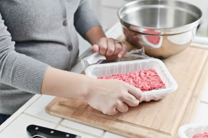 Opening hamburger to prepare poor man's steak.